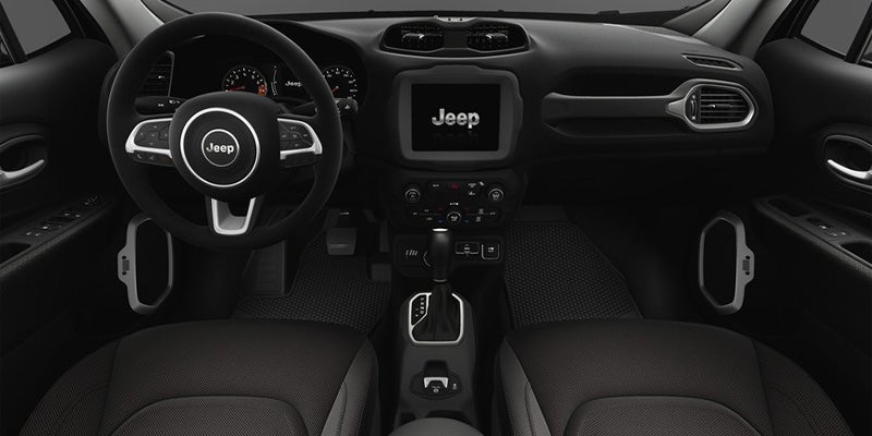 Interior view of dashboard and steering wheel in Jeep SUV