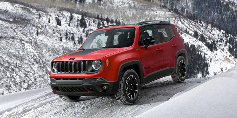 Front side view of Jeep Renegade driving in snow