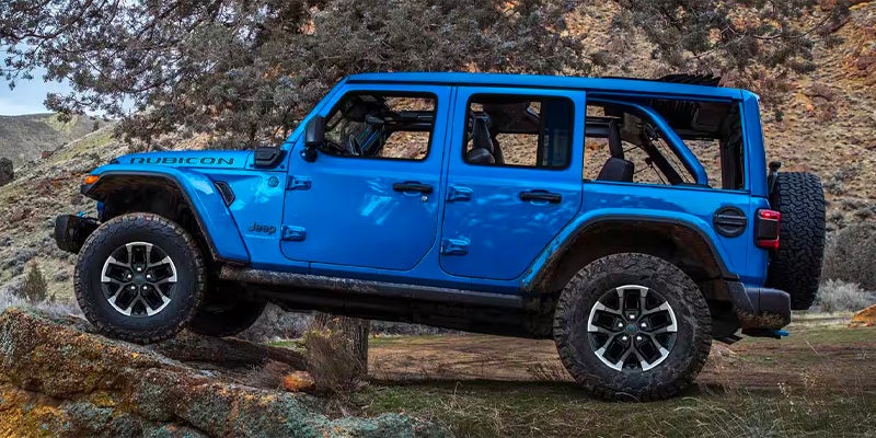 Side view of Jeep Wrangler 4xe parked outdoors