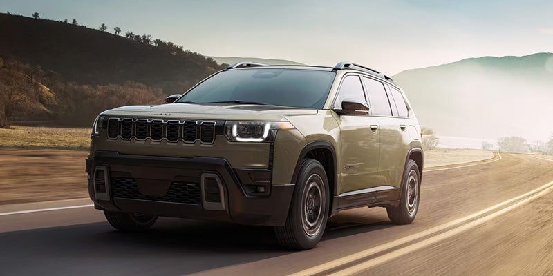 Front side view of Jeep Cherokee driving on road