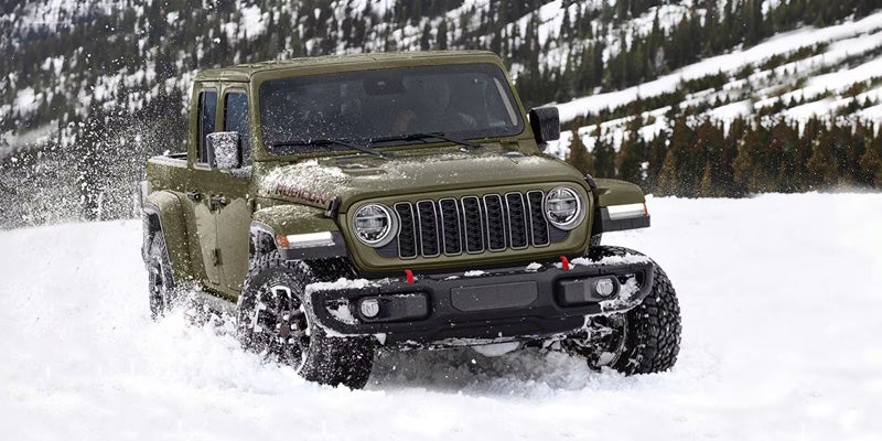 Front side view of Jeep Gladiator truck in snow