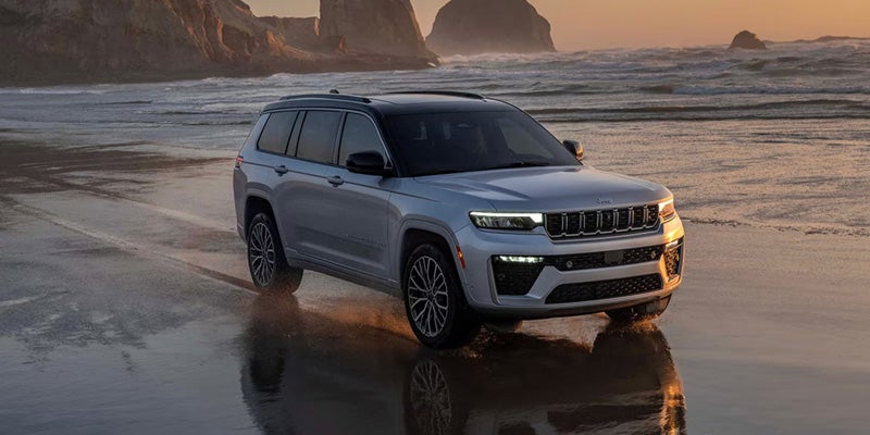 Front side view of Jeep Grand Cherokee on beach