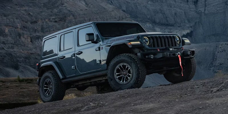 Front side view of Jeep Wrangler on rocky hill